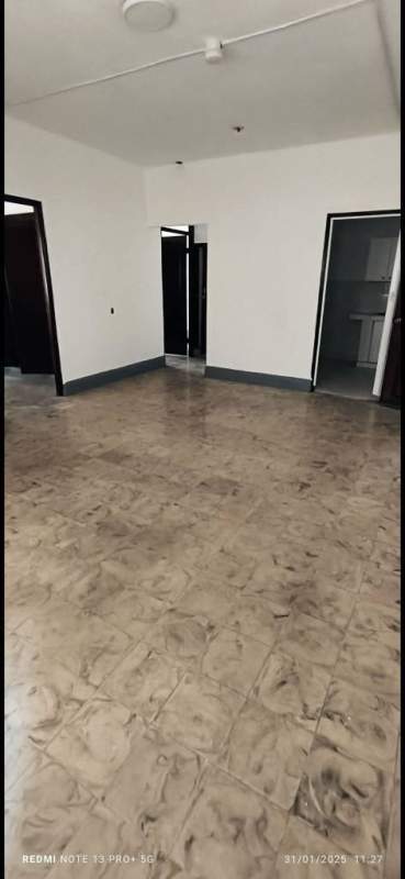 Basic kitchen with white cabinetry, countertop, tiled floor and window in PH Via Veneto Panama City