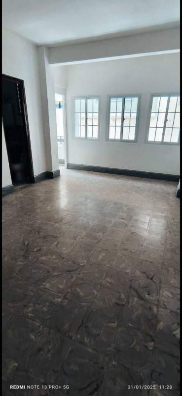Living room with several windows, tile floors, and ceiling fixture in PH Via Veneto El Cangrejo Panama City