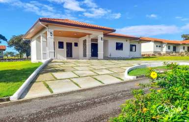 Front exterior of new Mediterranean home with garden, tile roof Boquete Panama