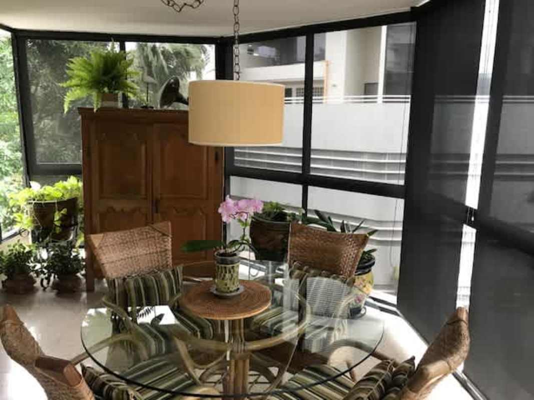 Indoor dining space with large windows, plants and natural lighting at PH El Cenit Bella Vista Panama