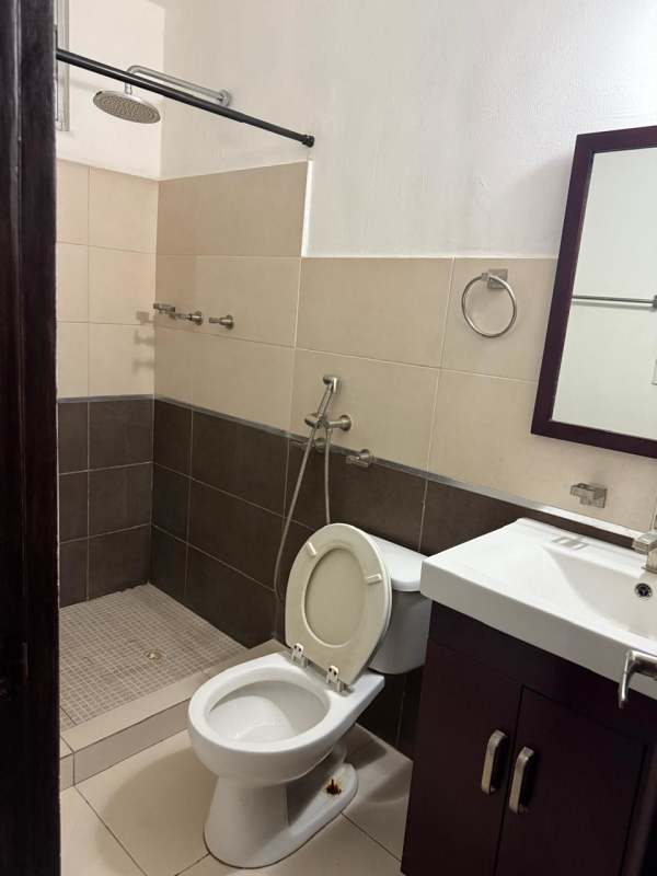 Interior hallway with tiled floors and dark wooden doors in PH Toscana Panama