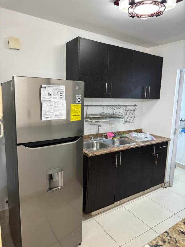 Kitchen with granite countertop, upper and lower cabinetry and appliances in PH Toscana Panama City