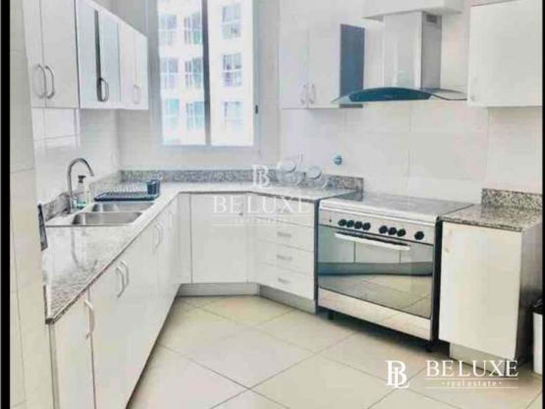 Fully equipped kitchen with granite countertops and modern appliances in PH Country Club Costa del Este