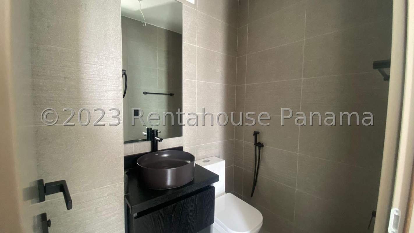 Minimalist bathroom with vessel sink, mirror and gray tiles in PH Victory Wellness Panama