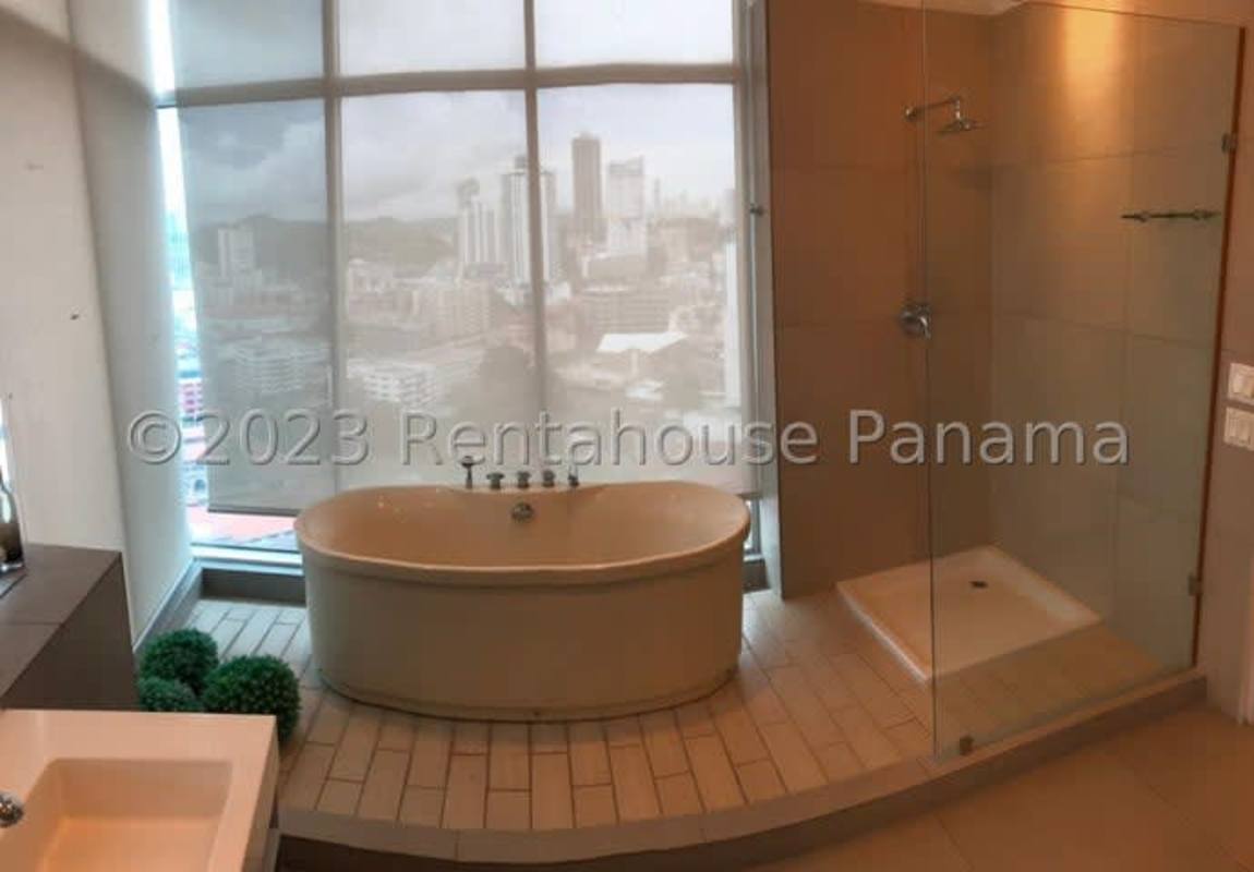 Bedroom with floor-to-ceiling glass wall panoramic views PH Yacht Club Tower Panama