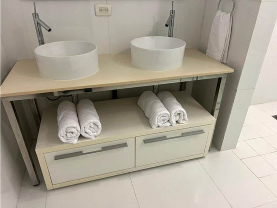 Bedroom with upholstered bed, large window with skyline views at PH Yoo Panama