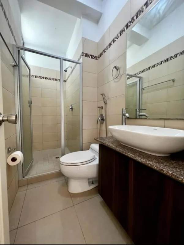 Bathroom with glass-enclosed shower, granite countertop, and modern fixtures in PH San Francisco Bay Panama