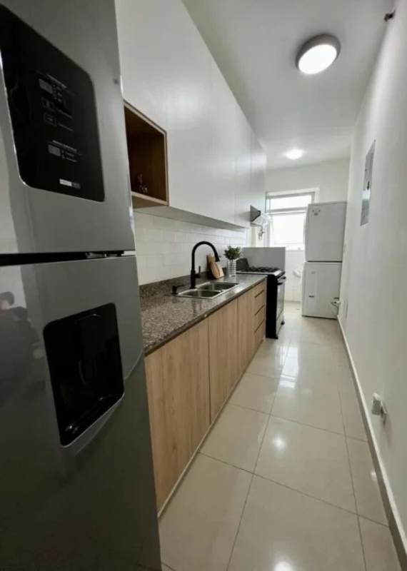 City view balcony in high-rise San Francisco Bay apartment, furnished outdoor seating with safety netting