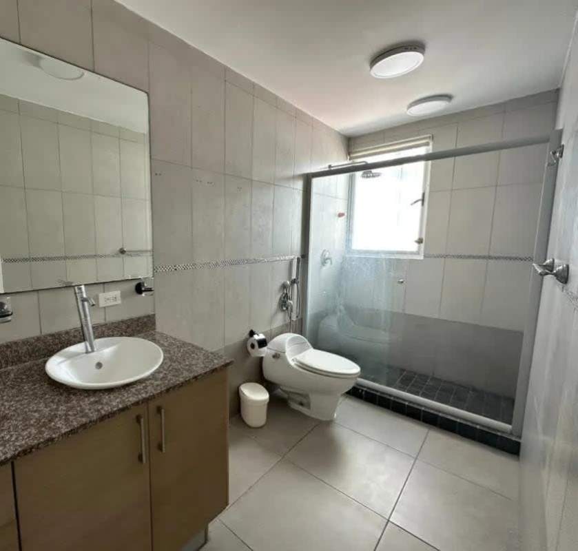 Modern bathroom with glass shower enclosure and granite vanity at PH Coco Del Mar Panama