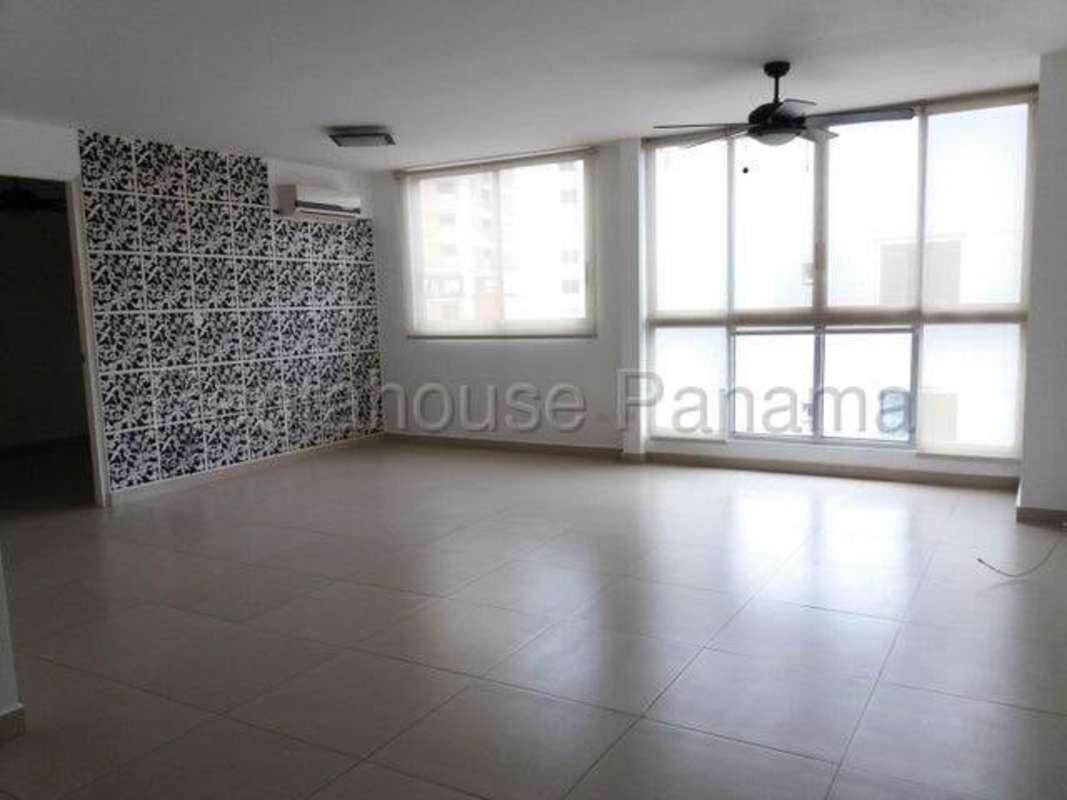 Bright living room with accent décor wall and tiled floor at Green Point Panama City