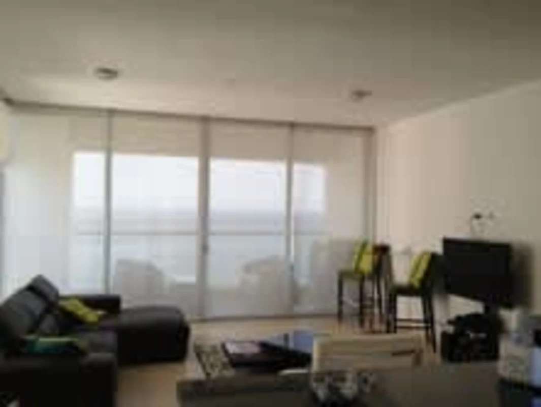 Living room with floor-to-ceiling windows, sectional sofa, ocean view PH Rivage Tower Panama City