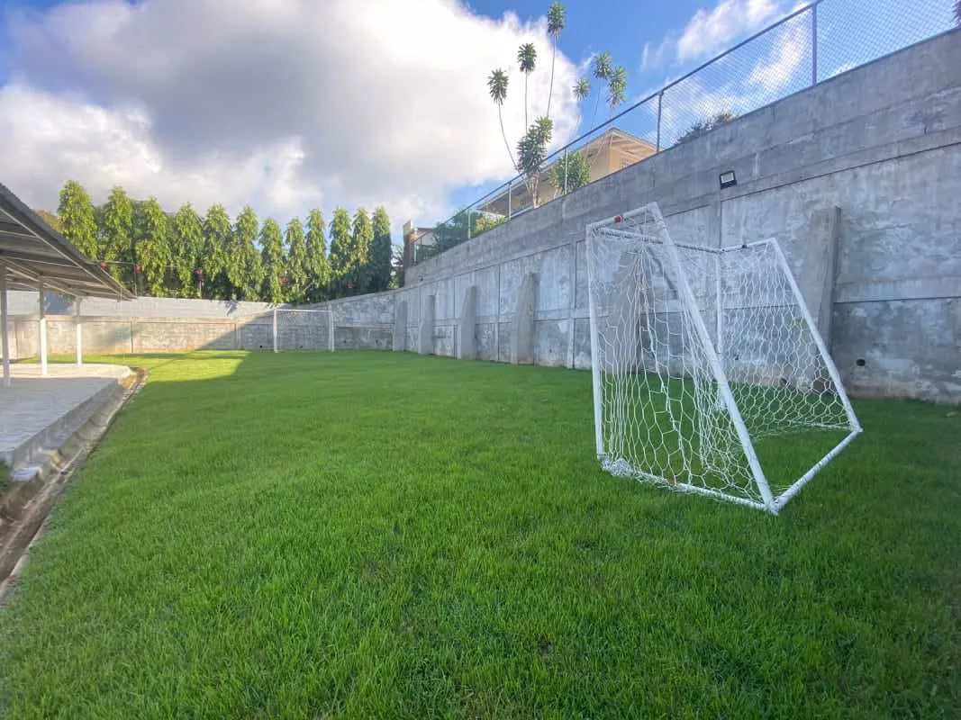 Bright living room with sectional sofa, TV, ceiling fan and AC in Panama rental house