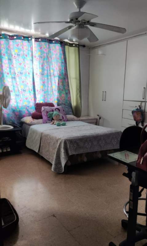 Large tiled outdoor terrace with tropical plants, white wall, ocean view in Coco del Mar Panama