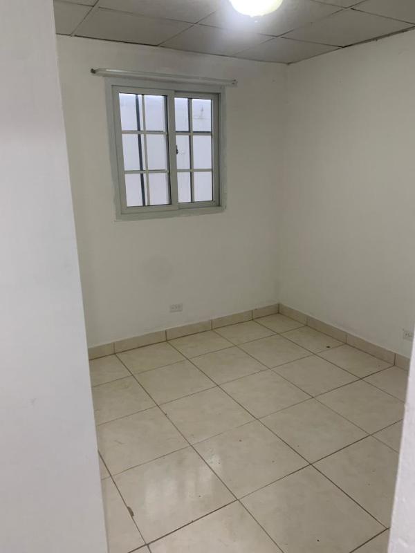 Bedroom with large window, tiled floor in affordable apartment Mateo Iturralde San Miguelito Panama