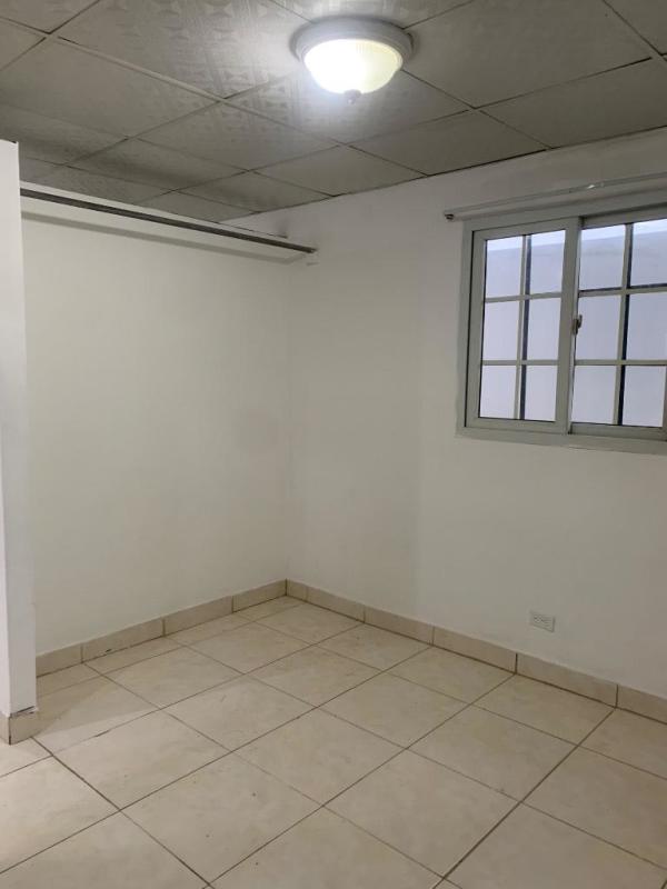 Empty tiled floor minimalist bedroom with ceiling fixture window Mateo Iturralde Panama