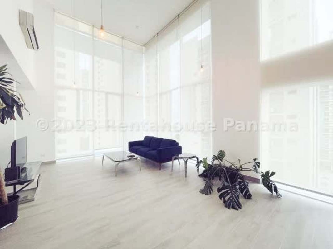 Modern minimalist living space with large windows, sofa and city view Bella Vista Panama