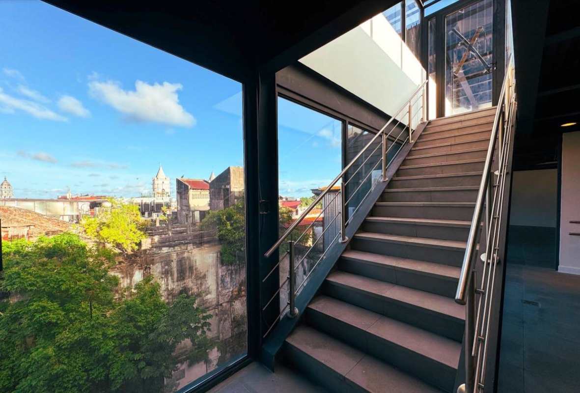 Hallway with glass walls, industrial stairs, tile floor commercial use Casco Viejo Panama