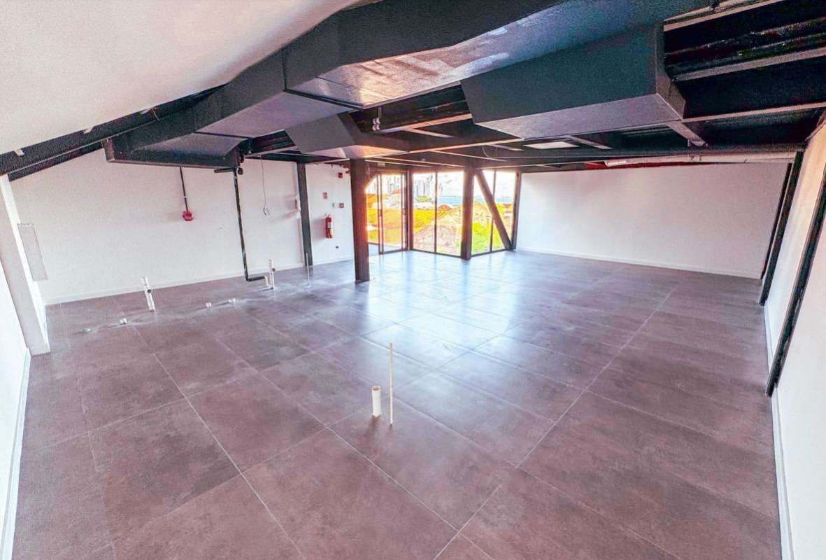 Open commercial space with exposed beams, large windows, tile floor Casco Antiguo Panama