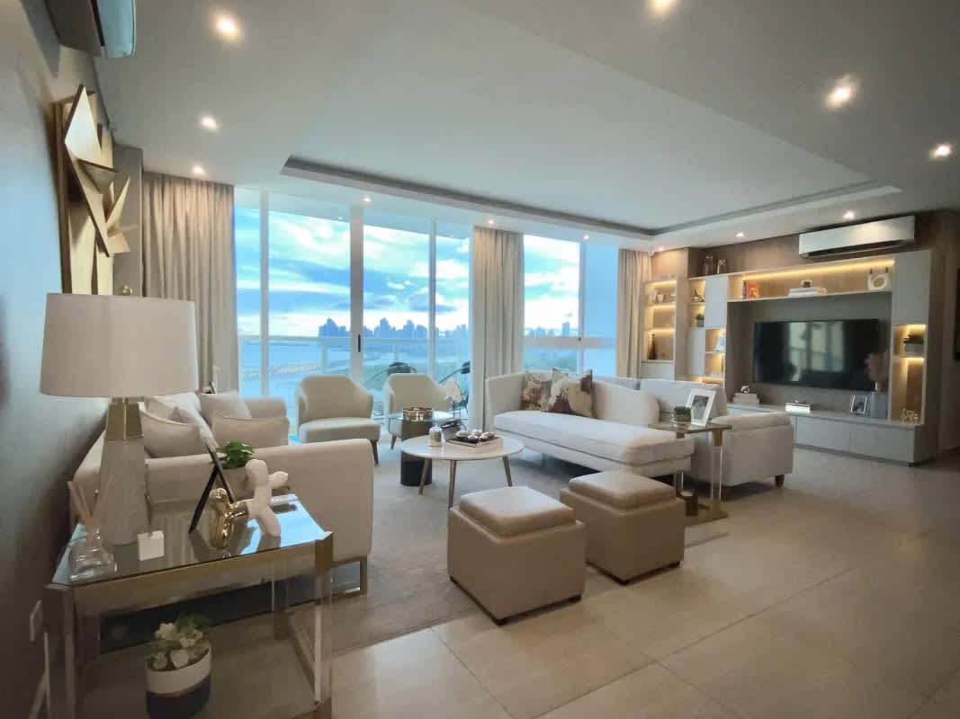 Spacious living room with large windows offering ocean and city skyline views at PH Asia Costa del Este