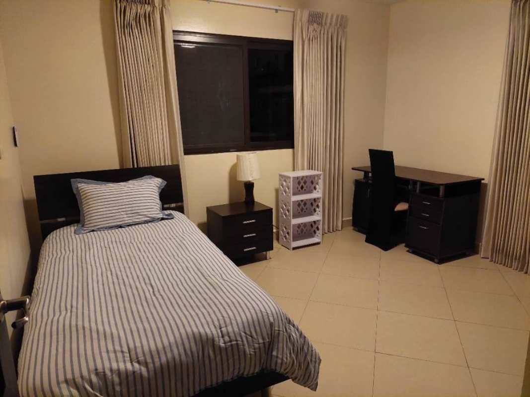 Spacious bedroom with built-in closet and AC in Embassy Club Clayton apartment