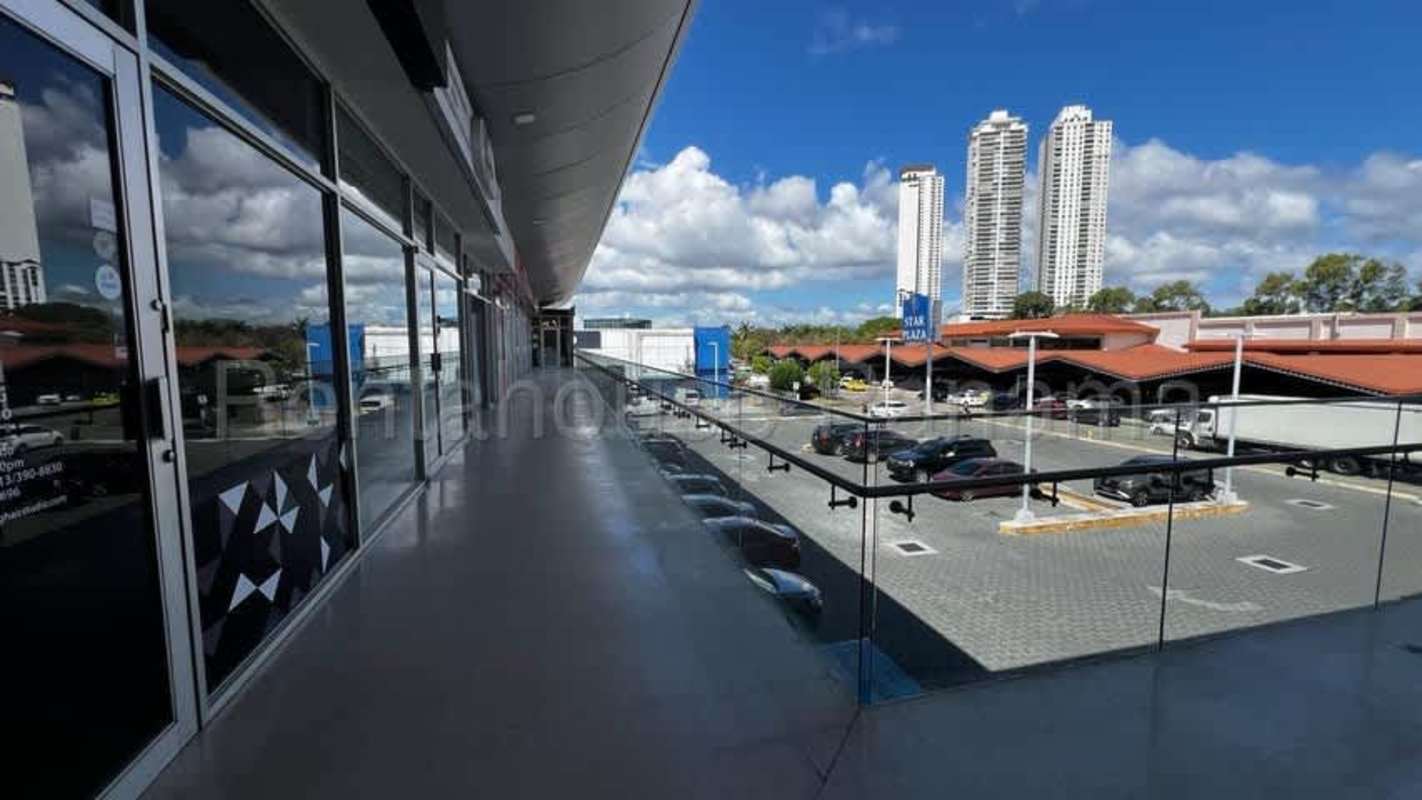 Balcony walkway overlooking commercial plaza and skyline Costa del Este Panama