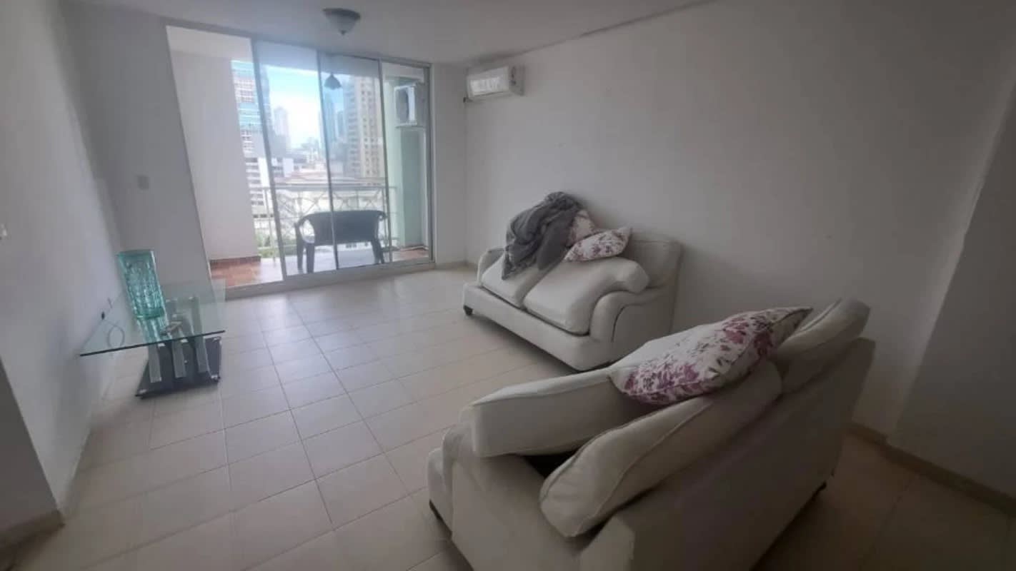 Spacious living room with sliding doors to balcony overlooking city skyline PH Plaza 77 El Cangrejo Panama