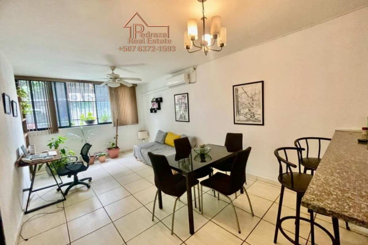 Open-plan living dining area with large windows, tiled floor, AC, ceiling fan in PH Villa del Sol Panama