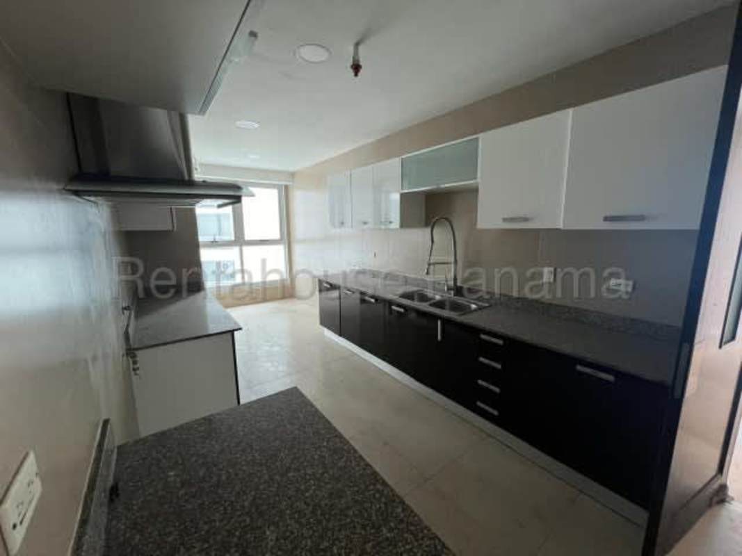 Kitchen with granite countertops, cabinets, marble floors in luxury Panama apartment for sale