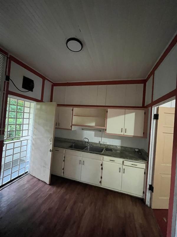 Basic tile kitchen with cabinet storage and sink in affordable upstairs rental Panama Clayton Balboa area
