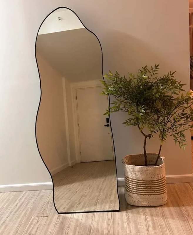 Modern entry space with wave mirror and potted plant minimalist apartment Panama