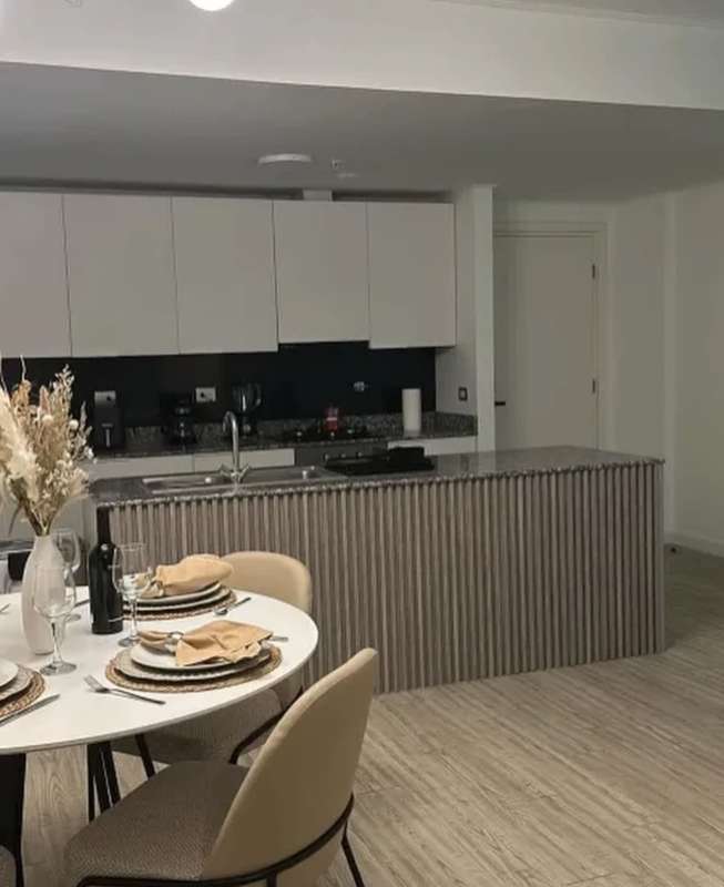 Panoramic city views from living dining area with modern furnishings in Panama apartment