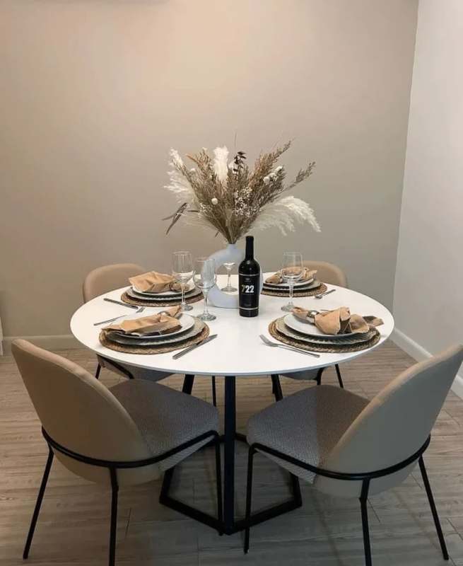 Modern living room with city view windows, neutral decor, and minimalist design in Panama