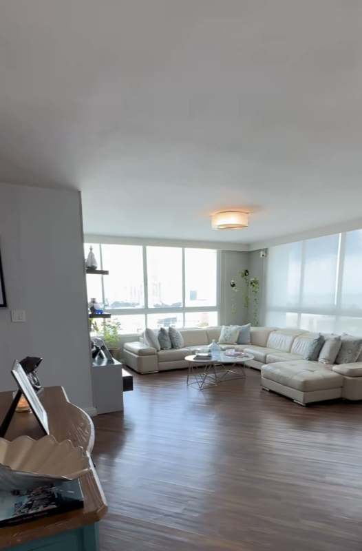Modern living room with large windows wood floors and city view PH Titanium Tower San Francisco Panama