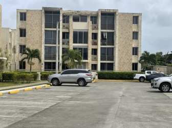 Compact kitchen with granite countertop and wood cabinetry at PH Terrazas del Oeste La Chorrera Panama