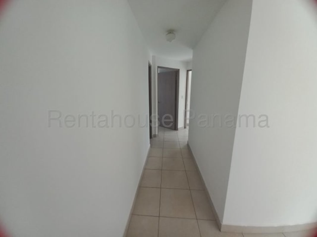 Open kitchen with granite countertops, dark wood cabinets, appliances at PH Edison Park Panama