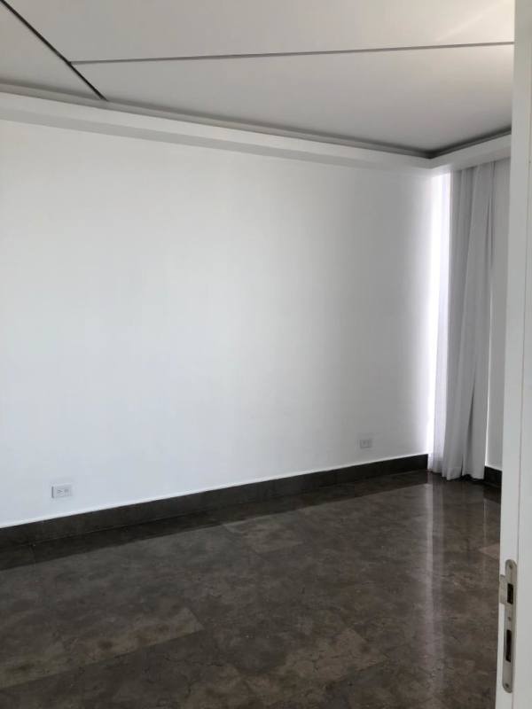 Bright bedroom with floor-to-ceiling window and city skyline view in YOO Panama