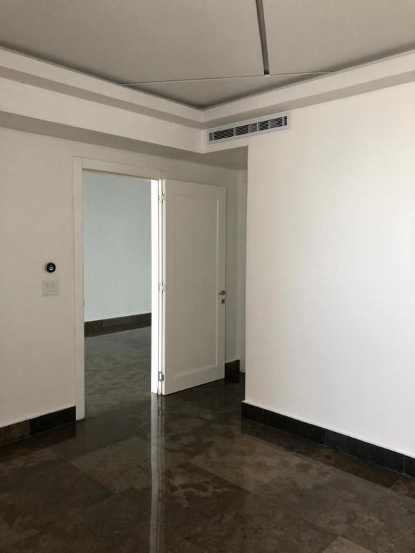 Elegant minimalist hallway with recessed lighting and marble floors at YOO Panama