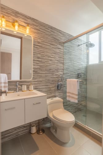 Balcony with skyline views, glass railing, and outdoor lounge at PH Metropolitan One Panama City