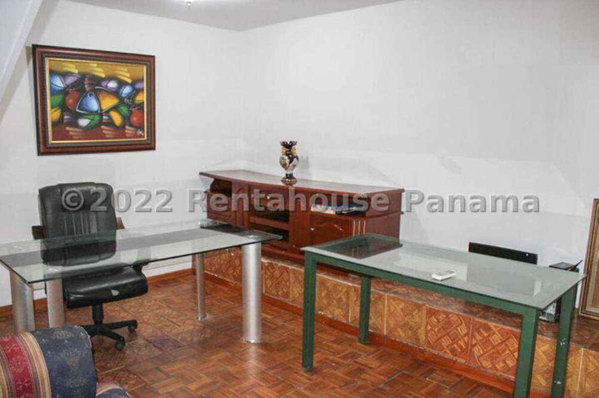 Interior with built-in bookshelves and office desks multi-level house Panama