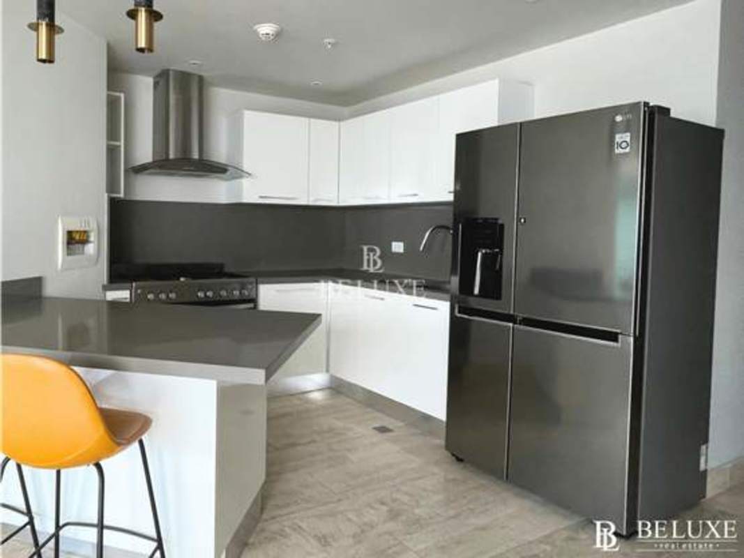 Contemporary kitchen with granite countertop and breakfast bar in The Regent Costa del Este Panama