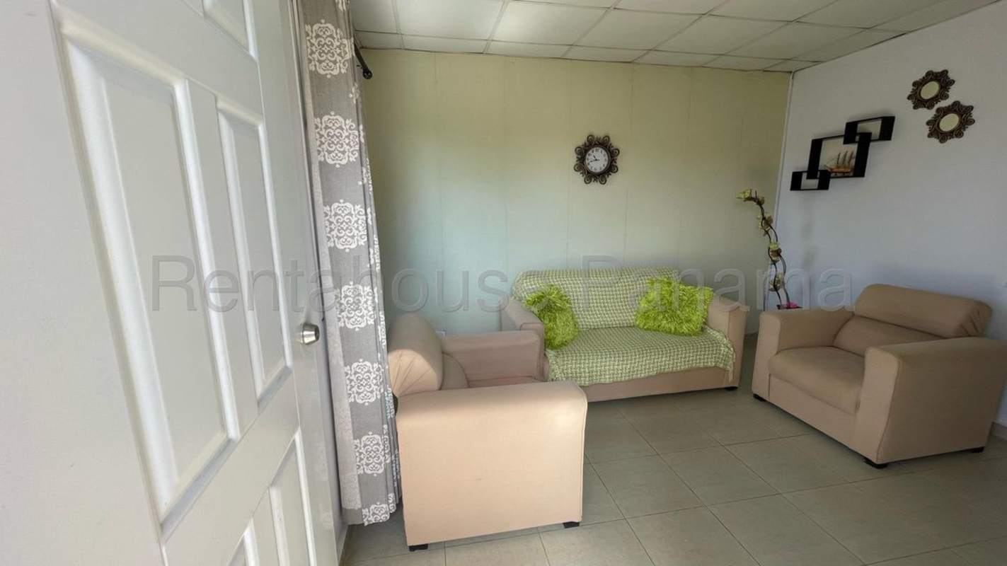 Interior living dining space with tile floors, sofa set in Pacora Gardens house Panama