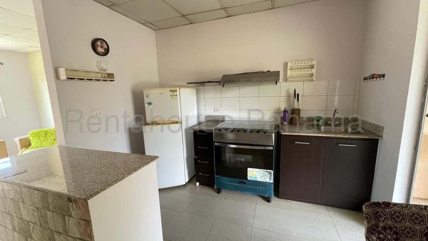 Small kitchen with granite countertops, tile backsplash and appliances in Pacora Gardens Panama house for rent