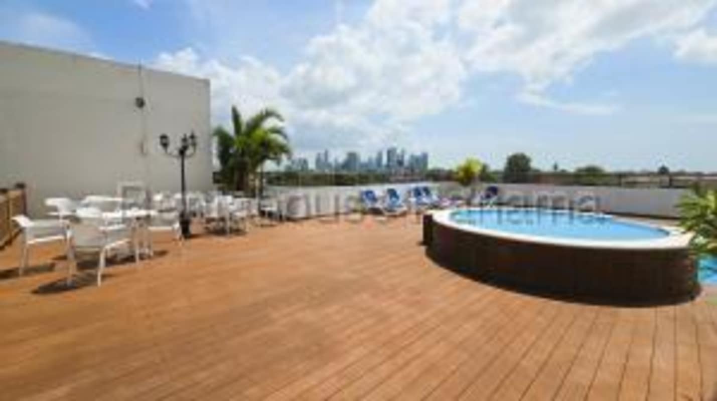 Terrace with round swimming pool and wood deck overlooking Panama City skyline PH Lefevre 75