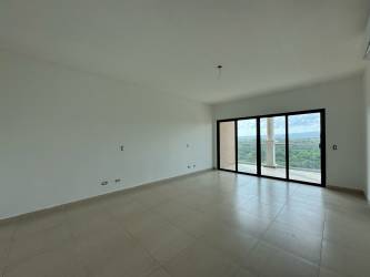 Bedroom with large window, terrace access and ocean golf views in Vista Mar penthouse Panama