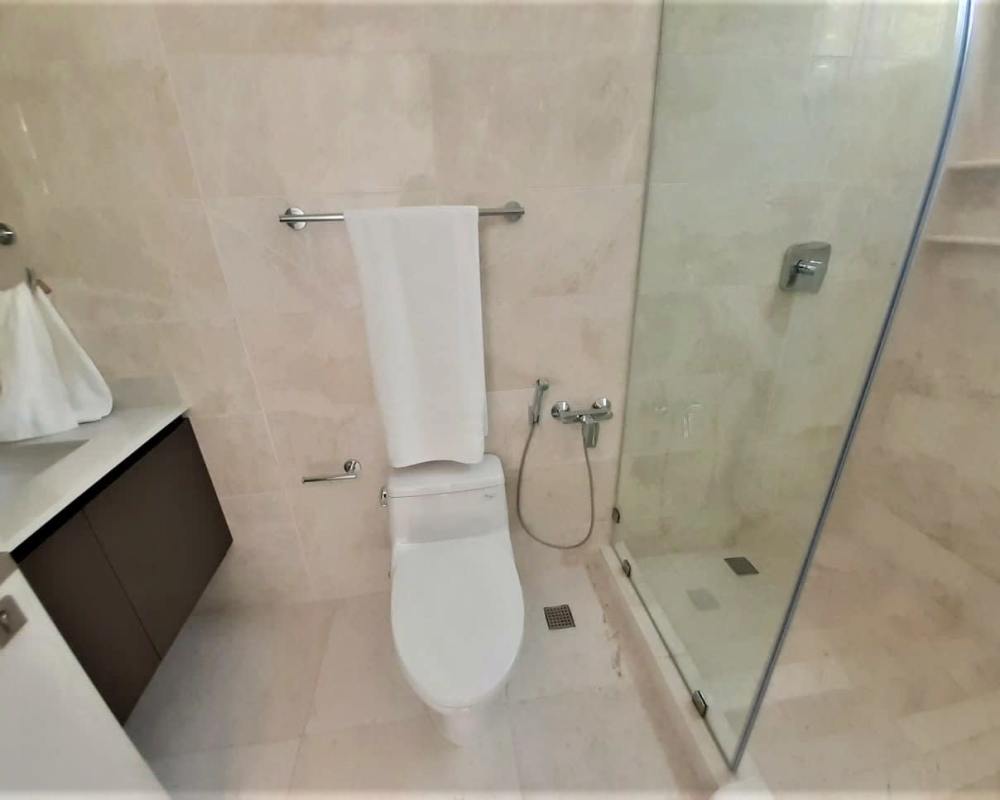 Modern living room with marble floors and panoramic windows overlooking Pacific Ocean in Pacific Point Panama