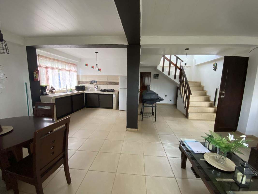 Enclosed sunroom balcony with panoramic mountain views in Panama nature farm