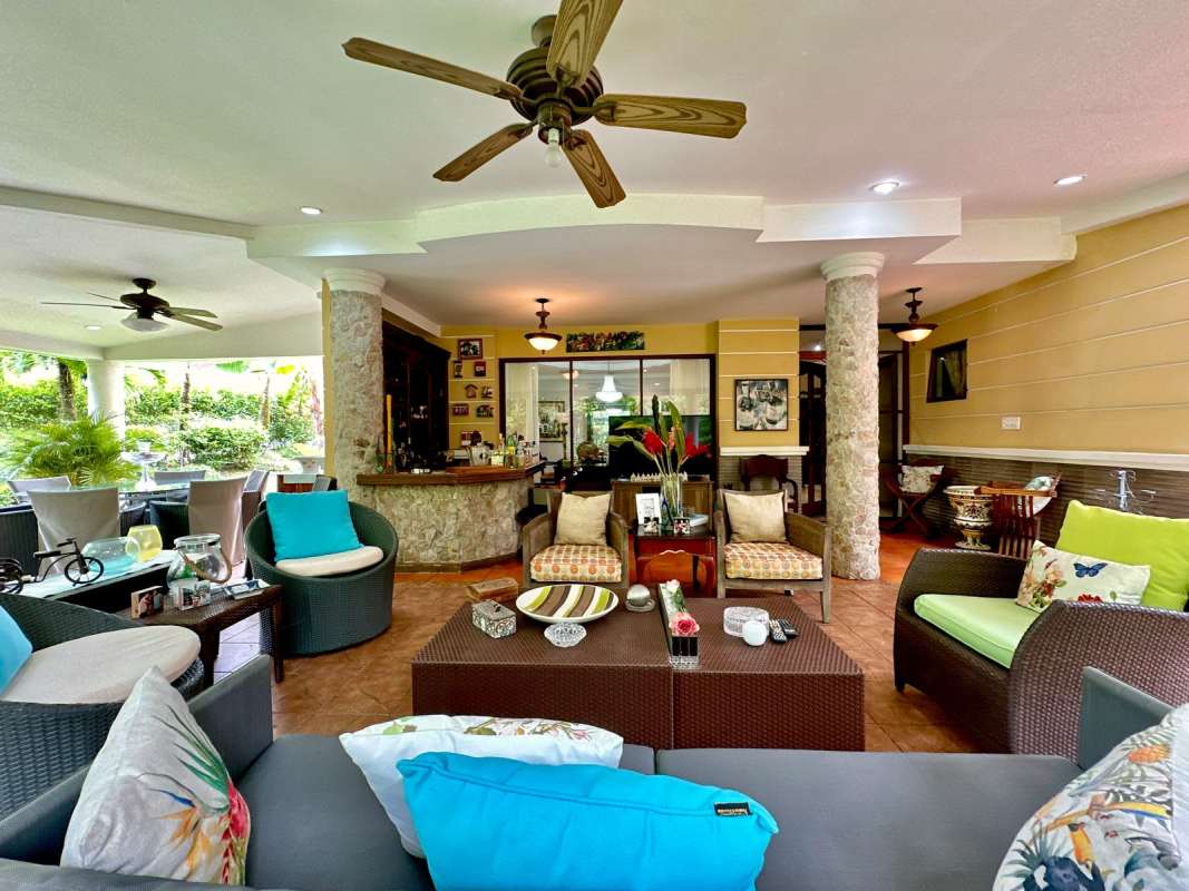 Spacious covered patio outdoor lounge with greenery perfect for entertaining El Dorado home in Panama