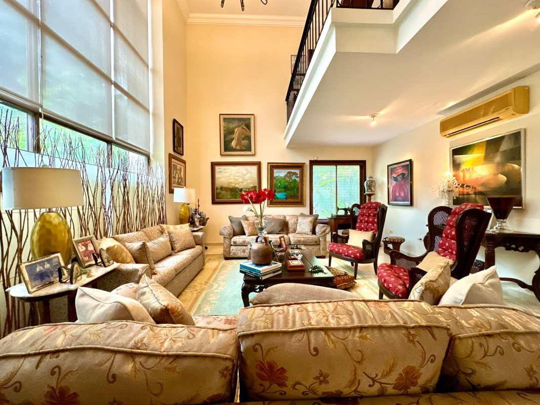 Elegant double-height living room with natural light and garden views in a luxury home El Dorado Panama