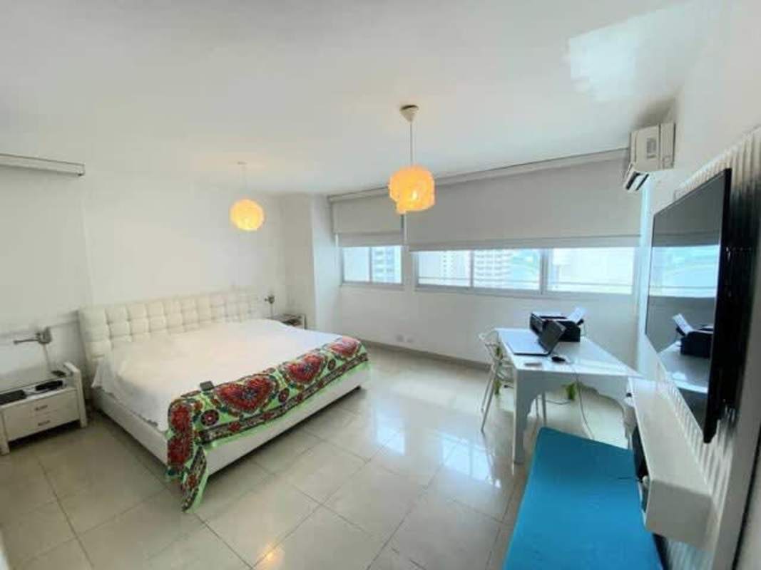 Modern bathroom with glass shower, granite countertop, neutral tile in PH Quadrant Panama