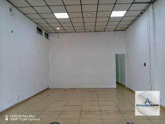 Open interior of commercial retail or office in Bugaba with white walls and drop ceiling